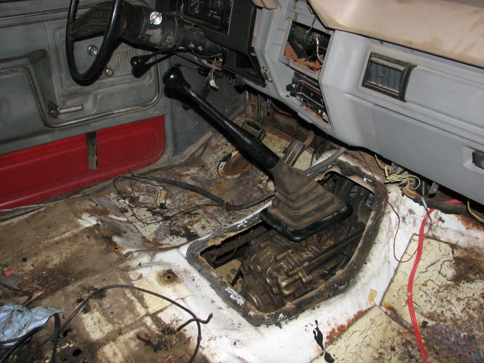 Interior of a 1984 Ford Bronco II with a manual transmission, showing exposed floor and transmission tunnel