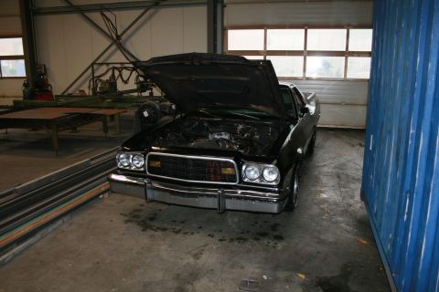 1973 Ford Ranchero - This 1977 Ford Ranchero is parked inside a garage with its hood up, revealing the engine bay.