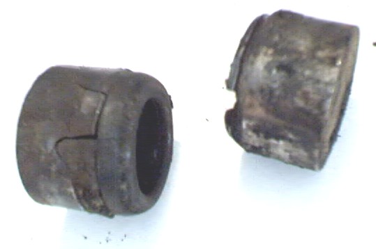 Side view of caps. One on the left is cracked and the one on the right has a small chunk gone.