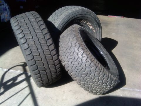 1986 Ford Bronco - Three tires are shown on a concrete surface, one with BFGoodrich T/A KR branding.