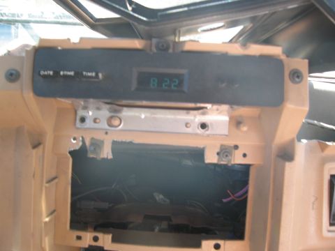 1986 Ford Bronco - Interior view of a vehicle's dashboard, focusing on a digital clock and surrounding trim.