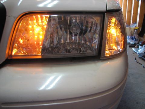 2003 Ford Crown Victoria - Front view of a 2003 Ford Crown Victoria, highlighting the illuminated turn signal.