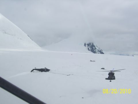1990 Chevrolet Suburban - A scene of helicopters and a downed aircraft in a snowy, mountainous environment, dated August 20, 2010.