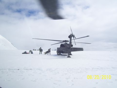 1990 Chevrolet Suburban - People are seen unloading cargo from a helicopter in a snowy landscape.