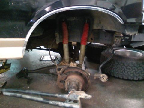 1990 Ford Bronco - Front suspension and brake components removed from a 1990 Ford Bronco during service.