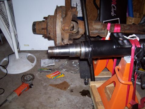 1994 Ford Bronco - Front axle assembly, possibly from a 1994 Ford Bronco, is supported by jack stands.