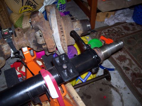 1994 Ford Bronco - A close-up view of a vehicle's axle and brake components, supported by orange jack stands.