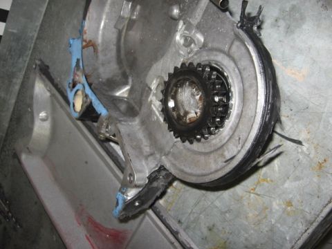 1965 Ford Fairlane - Close-up view of an engine component a gear and sealant material.