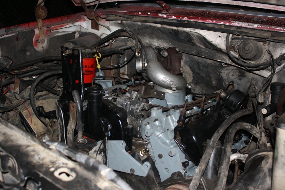 Engine bay with a turbocharger and red oil filter. The engine appears to be a diesel