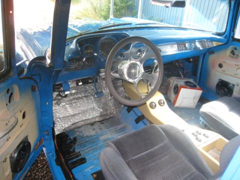 1957 Chevrolet Bel Air - Interior view of a 1957 Chevrolet Bel Air, a custom steering wheel and blue painted dashboard.