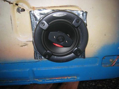 1957 Chevrolet Bel Air - Speaker installation in a car door panel, showing aftermarket modifications.