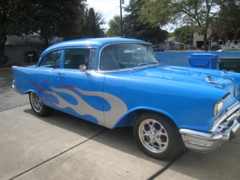 1957 Chevrolet Bel Air - This blue 1957 Chevrolet Bel Air sedan features custom silver and red flame graphics along its side.