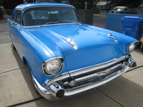 1957 Chevrolet Bel Air - Front view of a blue 1957 Chevrolet sedan with chrome accents.