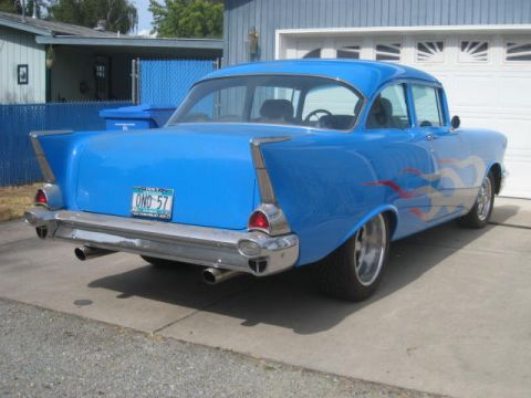 1957 Chevrolet Bel Air - Rear view of a blue 1957 Chevrolet Bel Air with flame decals and a custom license plate.