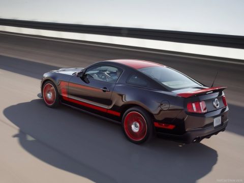 1973 Ford Ranchero - A black Ford Mustang with red accents speeds down the highway.