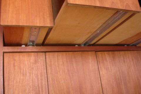 1993 Ford Taurus - Close-up view of wooden drawers and their metal slide mechanisms.