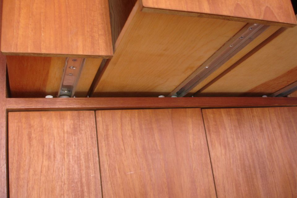 Wooden drawers with metal slides, viewed from below