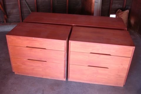 1993 Ford Taurus - Two wooden dressers with three drawers each are stored in a garage.