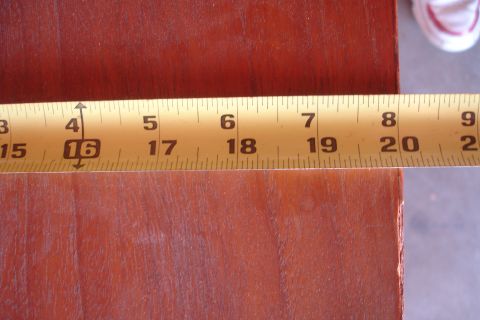 1993 Ford Taurus - A measuring tape is placed on a wooden surface, indicating a measurement of 16 inches.