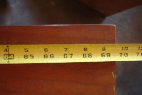 1993 Ford Taurus - A measuring tape is used to measure a wooden surface, showing inches from 64 to 71.