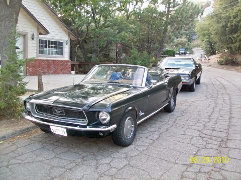 Dark green 1968 Ford Mustang convertible parked on a street