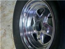 2004 Ford Mustang - A close-up view of a chrome wheel and tire.