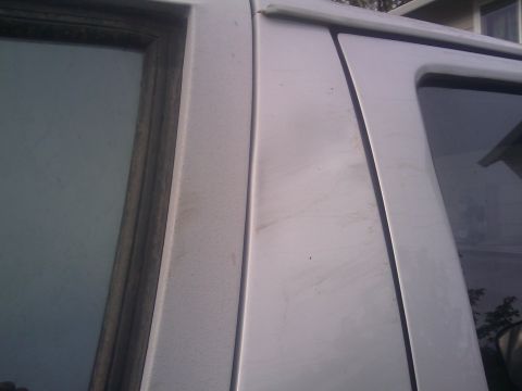 1996 Ford Bronco - Close-up of the side door frame and window trim on a 1996 Ford Bronco.