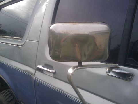 1996 Ford Bronco - Side view of a 1996 Ford Bronco, highlighting its chrome side mirror and two-tone paint.