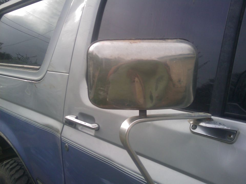 1996 Ford Bronco side view with chrome mirror