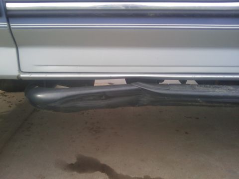 1996 Ford Bronco - Side view of a damaged running board on a vehicle.