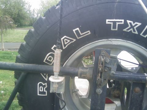 1996 Ford Bronco - Close-up of a spare tire and its mounting hardware, with an antenna attached to the rack.
