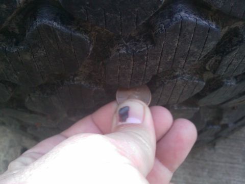 1996 Ford Bronco - Checking tire tread depth with a penny.