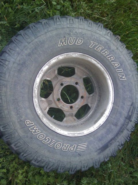 1996 Ford Bronco - A Mud Terrain tire with 'PROCOMP' and 'MUD TERRAIN' text is shown on a five-spoke wheel.