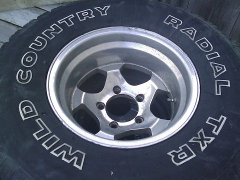 1996 Ford Bronco - Close-up of a Wild Country Radial TXR tire and a 5-spoke aluminum wheel.