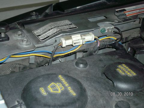 1996 Ford Bronco - Close-up view of electrical connectors and wiring within a vehicle's engine bay.