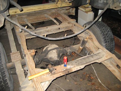 1988 Ford Bronco - The underside of a vehicle, showing the frame and rear axle assembly, is visible in this photograph.