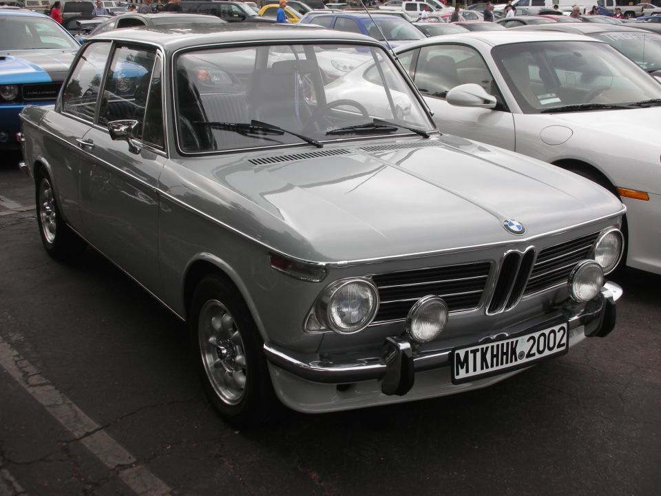 Silver BMW 2002 with chrome trim and auxiliary lights