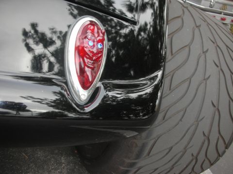 1998 Ford Crown Victoria - Custom devil taillight on a black vehicle, next to a tire.