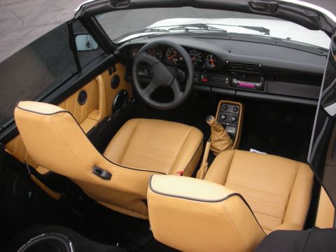 1998 Ford Crown Victoria - Interior view of a tan leather-equipped Porsche 911 convertible.
