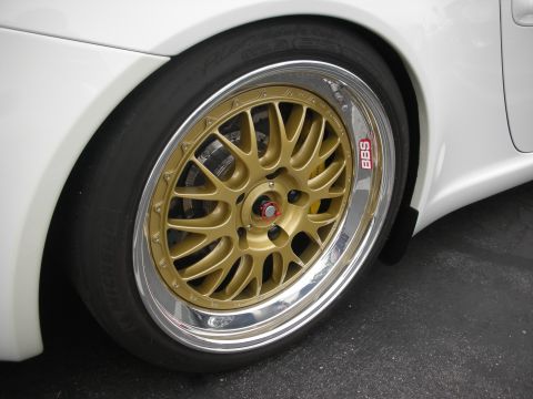 1998 Ford Crown Victoria - Close-up of a gold BBS wheel with a polished lip on a white car.