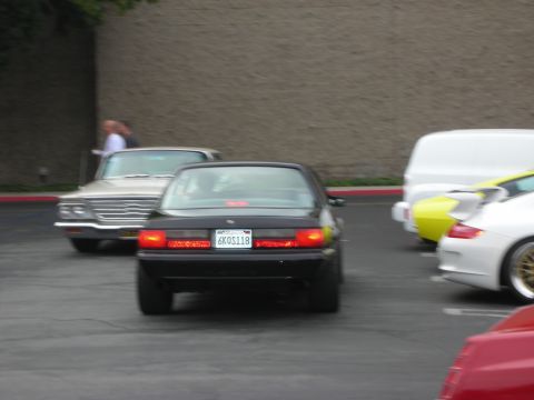1998 Ford Crown Victoria - A black sedan is parked next to other vehicles in a lot.