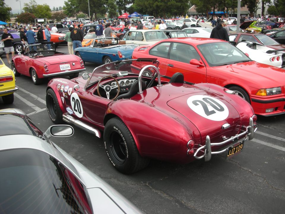 Red convertible with racing number 20 on rear and side, JJZ 109 license plate