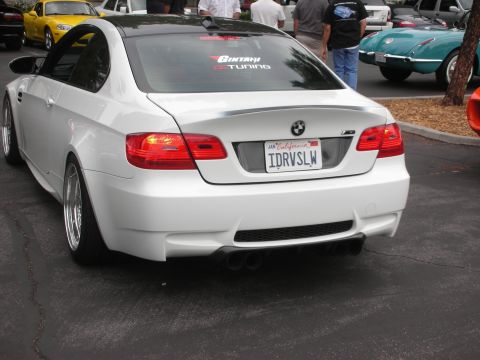 1998 Ford Crown Victoria - A white BMW M3 Coupe is parked at an outdoor gathering with other vehicles visible.