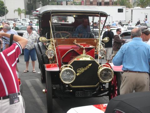 1998 Ford Crown Victoria - A vintage Pierce-Arrow automobile is displayed at an outdoor event with several people around it.