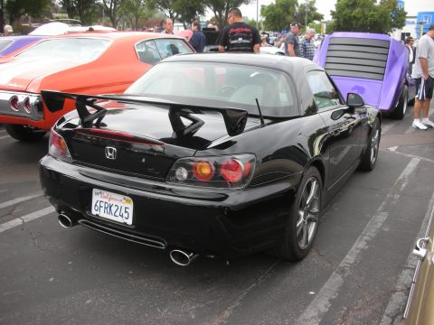 1998 Ford Crown Victoria - Rear view of a black Honda S2000 at a car meet, with other vehicles in the background.