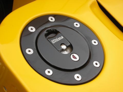 1998 Ford Crown Victoria - Fuel filler cap with 'Ultima' branding on a yellow vehicle.