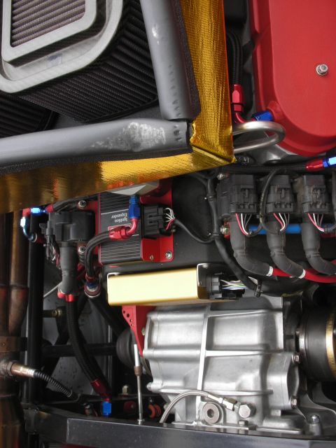 1998 Ford Crown Victoria - Close-up view of a modified engine bay, showing various aftermarket components and wiring harnesses.