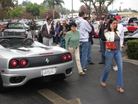 1998 Ford Crown Victoria - A group of people are gathered around a silver Ferrari 360 Spider at an outdoor event.
