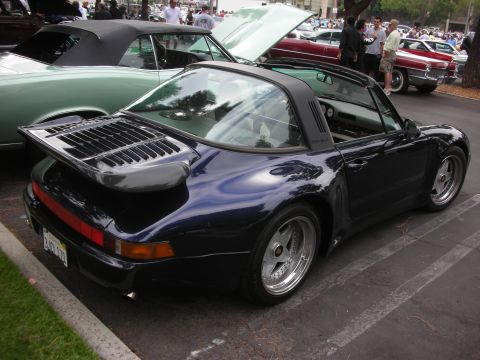 1998 Ford Crown Victoria - A dark blue Porsche 911 Targa is parked at an outdoor car meet, with other vehicles visible.