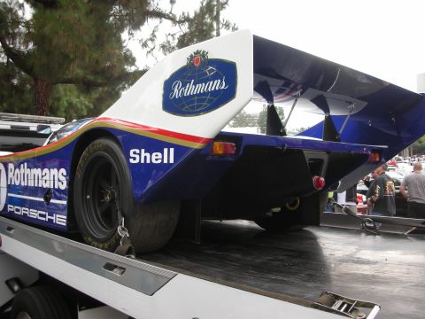 1998 Ford Crown Victoria - A Rothmans-liveried Porsche race car is loaded onto a tow truck.